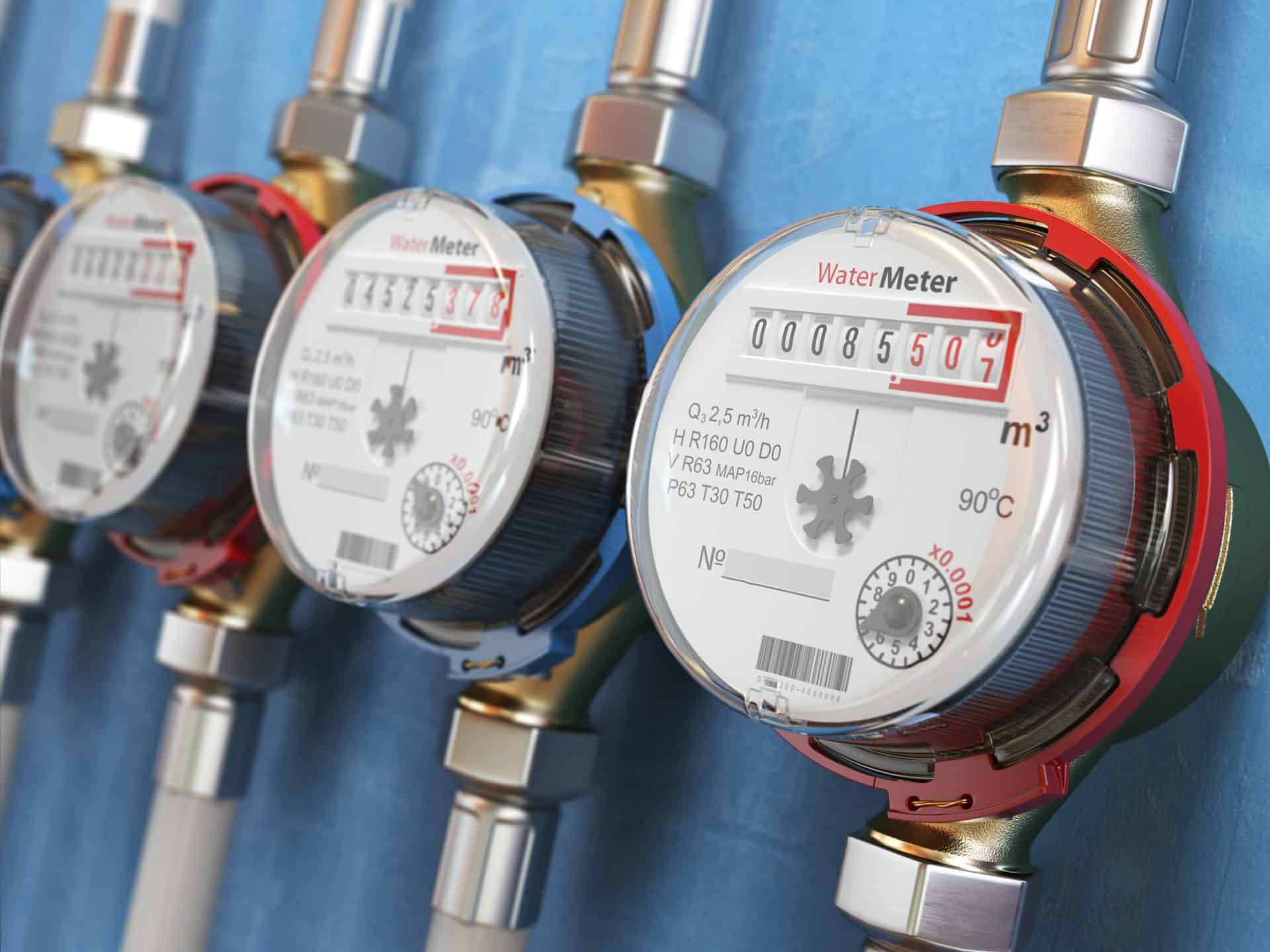 Row of water meters of cold and hot water on the wall background. 3d illustration